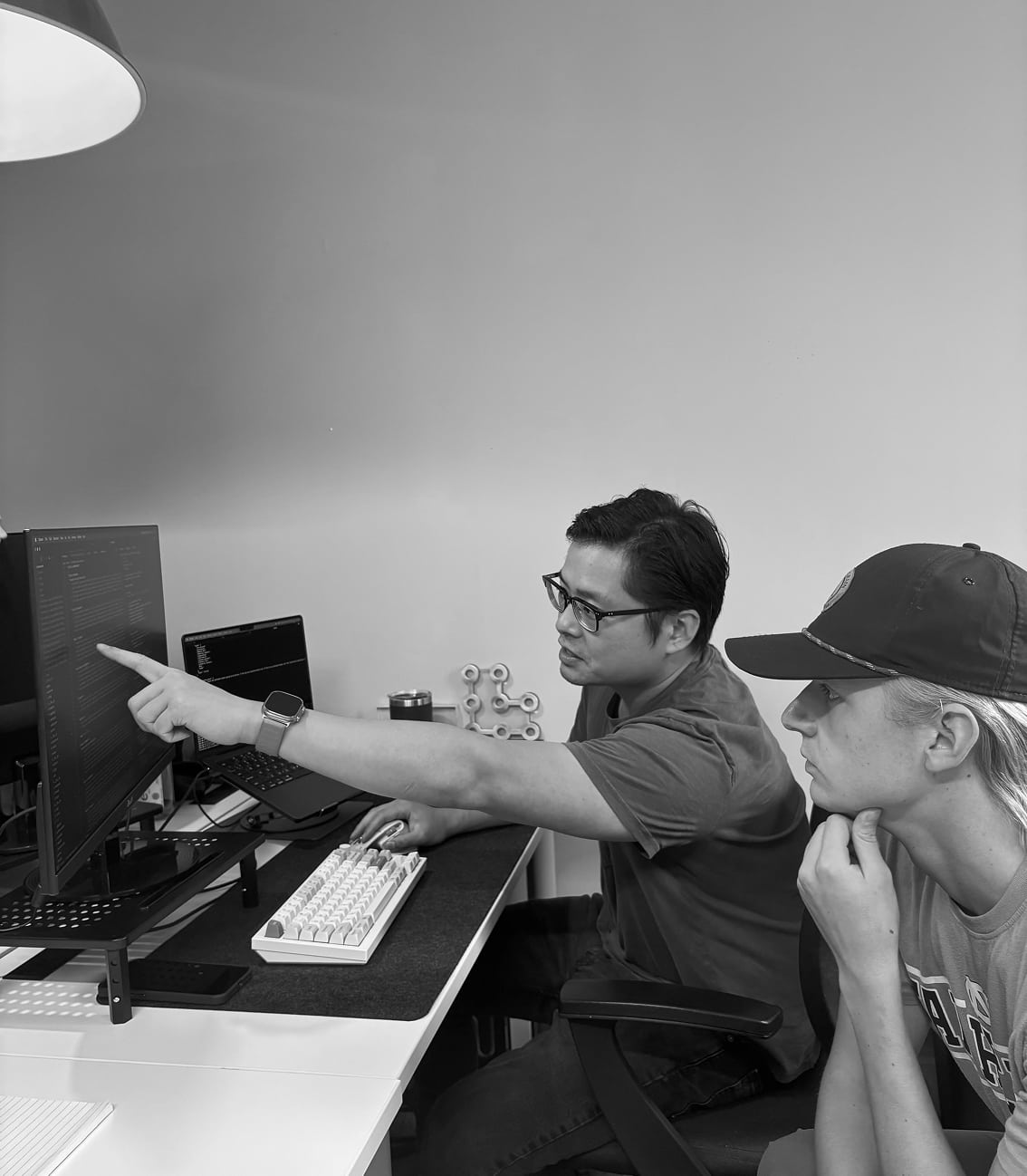 Underwriters reviewing insurance data on a monitor.